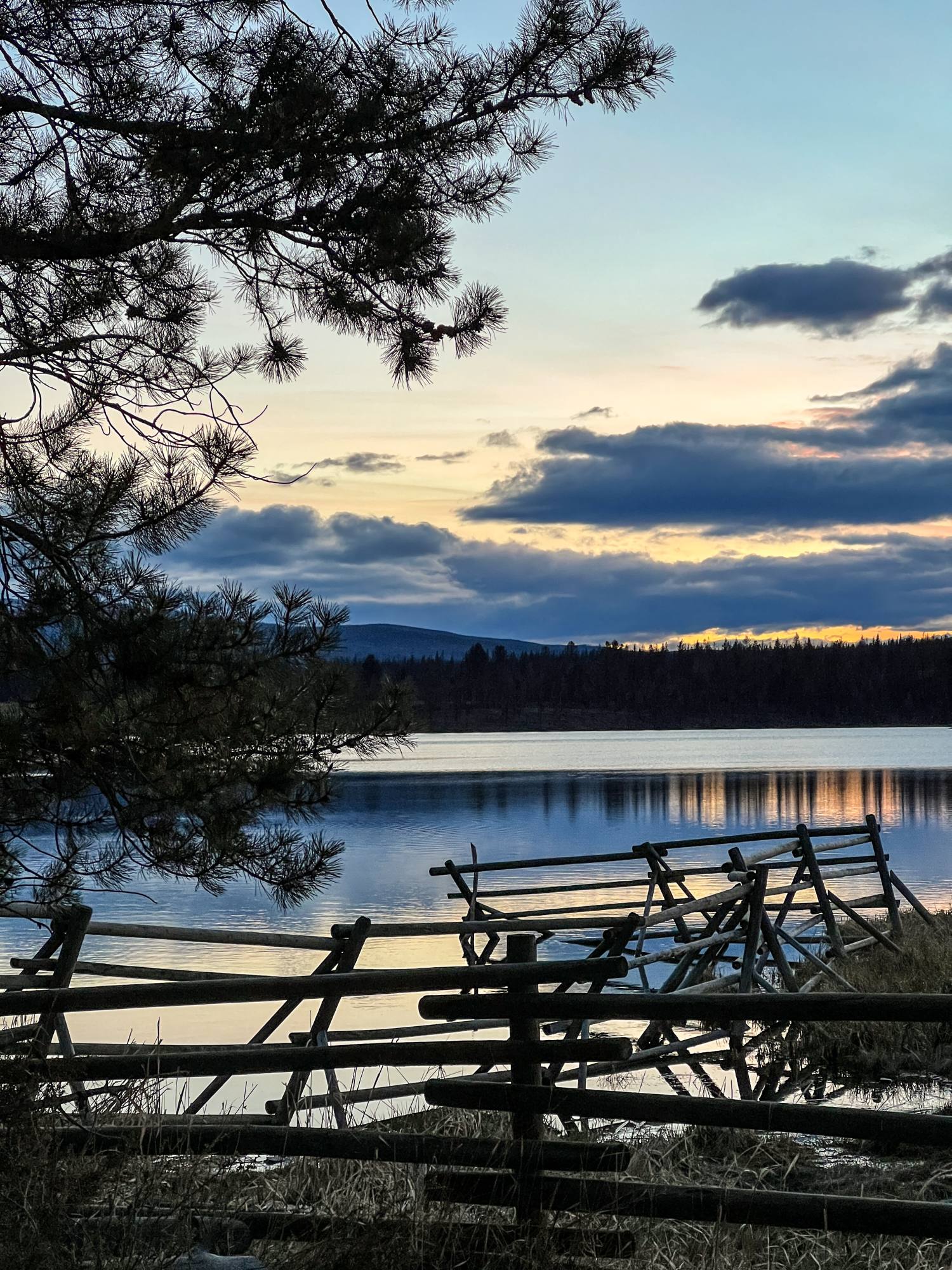 Rustic log fence at the edge of Leighton Lake at dusk